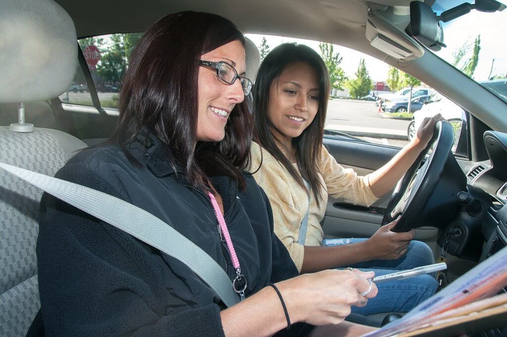 Examiner giving feedback following a driving test